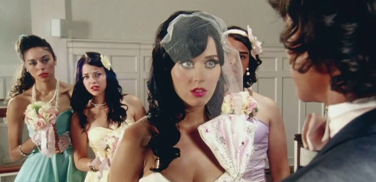 Katy Perry in a wedding dress, looking apprehensive