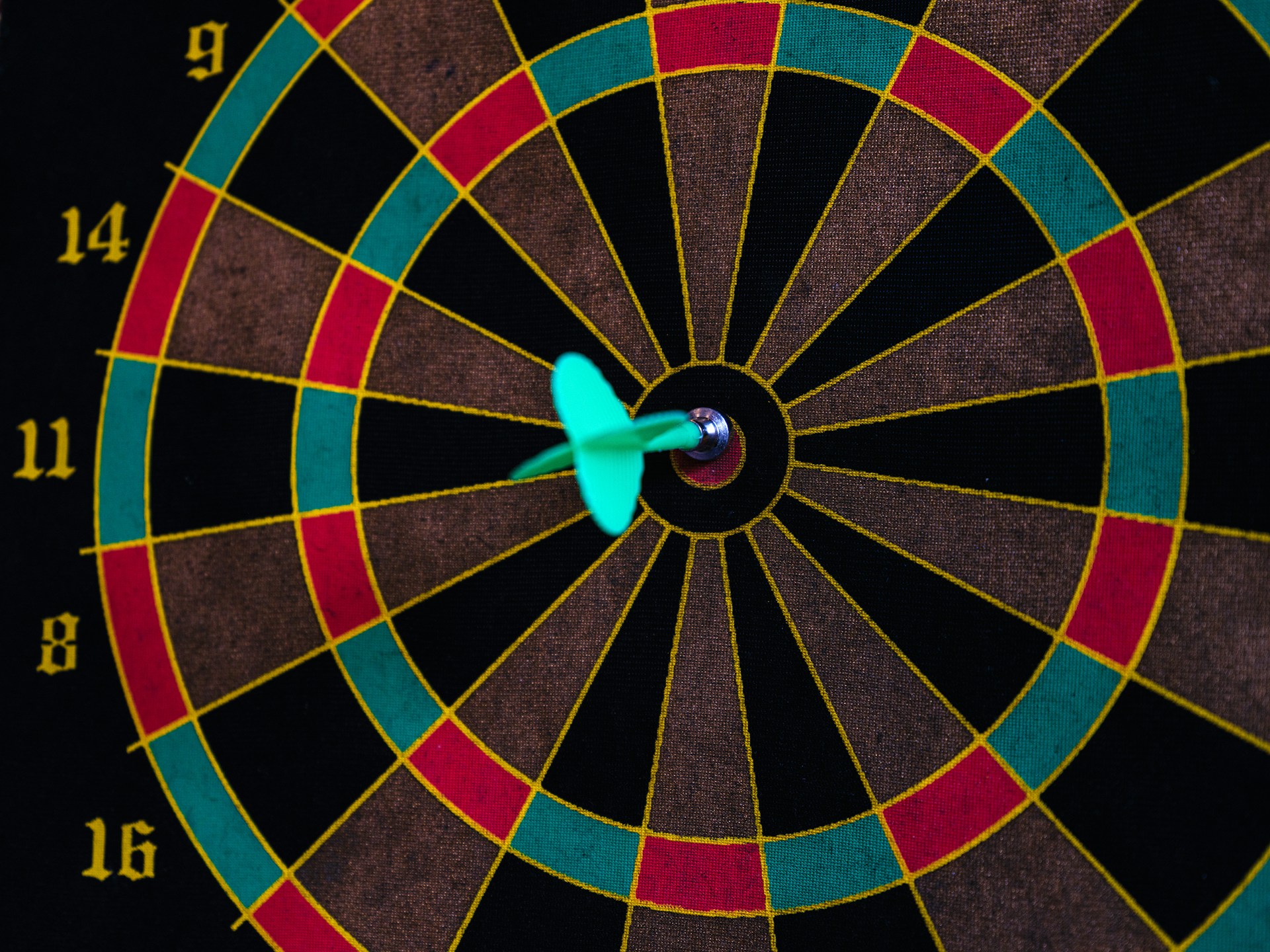 A dartboard with a dart on the bullseye